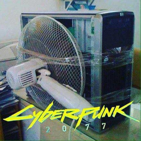 This meme is a screenshot of a 1990s computer desktop, with a Windows 95 icon in the background. In the foreground, a fan is stuck in a computer case, with the words "CYBERPUNK 2077" written in a futuristic font. The image is likely a humorous take on the idea of a computer malfunctioning in a futuristic, high-tech world.